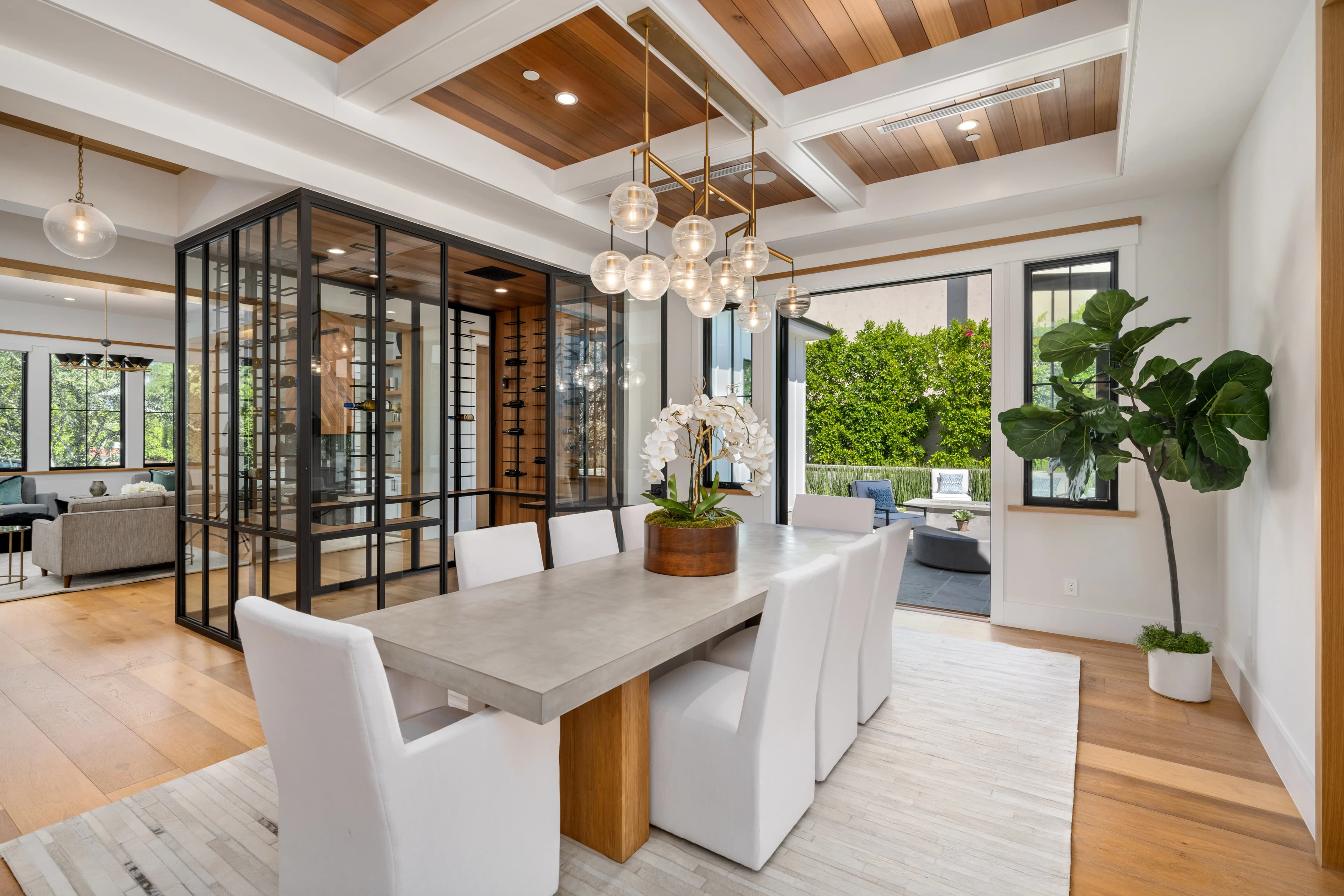Modern dining room with a stone table and a glass wine wall